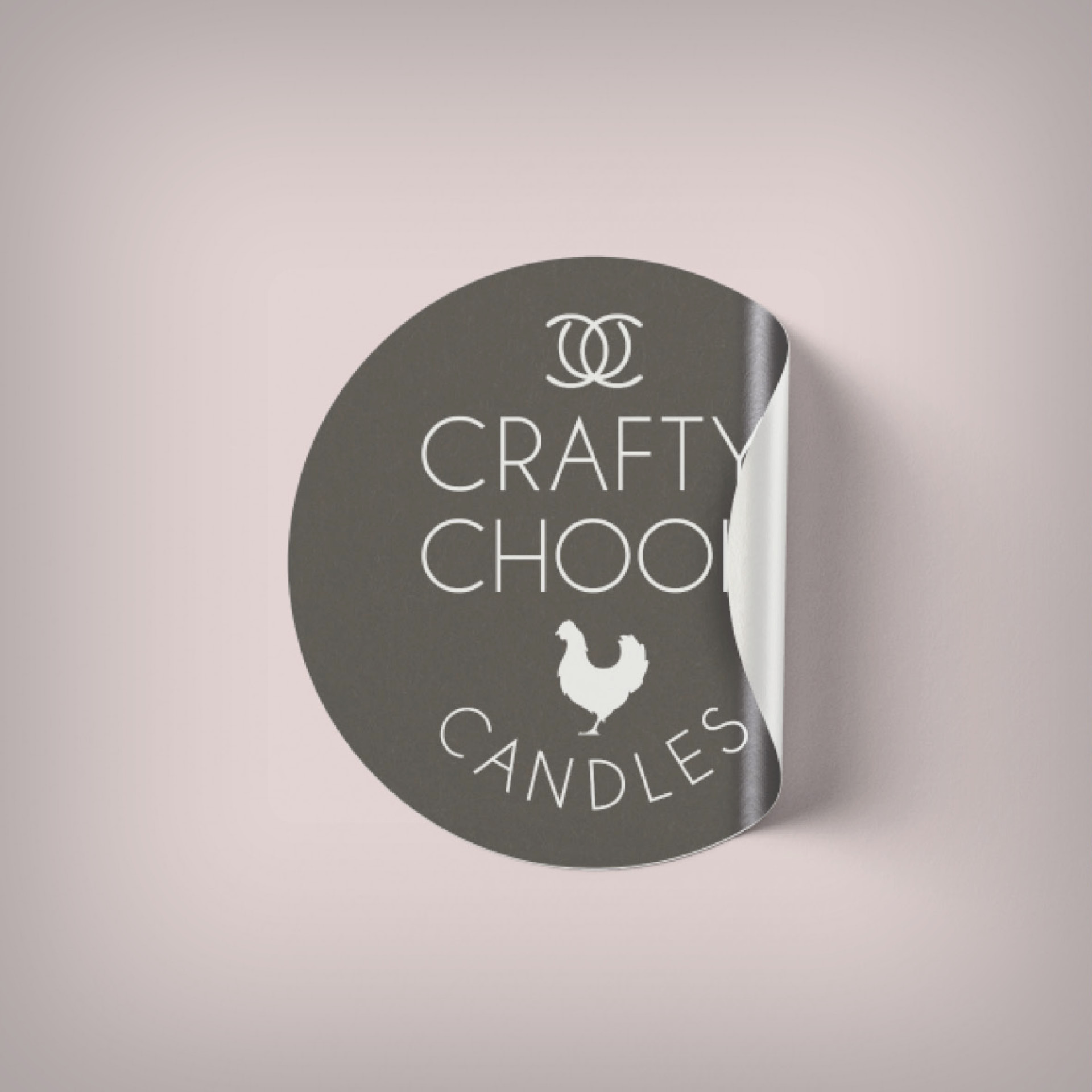 Black Crafty Chook Candles sticker against a pink background